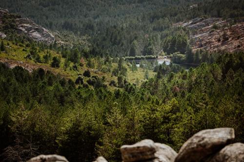 a view of a lake from a mountain at Vallicciola Nature Hotel in Tempio Pausania
