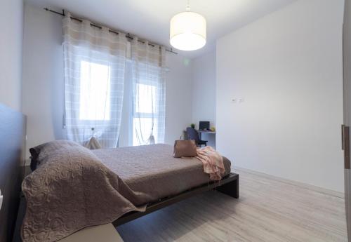 a bedroom with a bed and a large window at Le Casette Di Osvaldo in Lecco