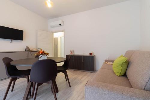 a living room with a couch and a table at Le Casette Di Osvaldo in Lecco