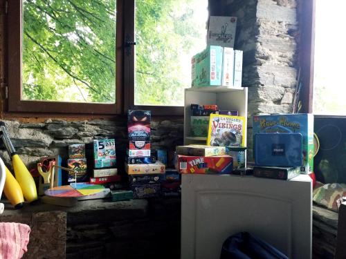 a room with a bunch of books on a table at la feuille de choux ( le MàS du Plot) in Sablières