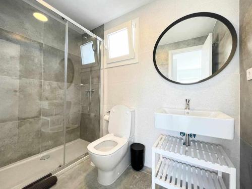 a bathroom with a toilet and a sink and a mirror at Tarifa Beach Rentals Sunset in Tarifa