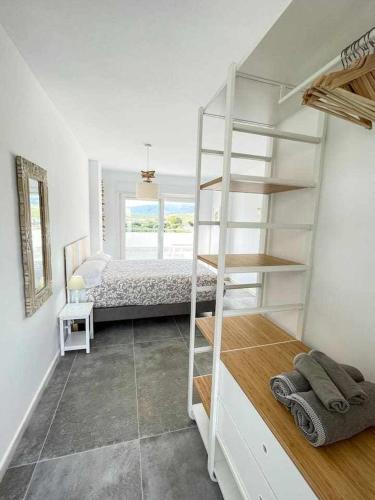 a bedroom with a bunk bed and a ladder at Tarifa Beach Rentals Sunset in Tarifa