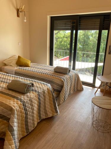 En eller flere senge i et værelse på Casa ponto Da Cruz t3