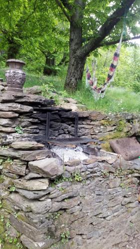 a stone wall with a bench on top of it at la feuille de choux ( le MàS du Plot) in Sablières