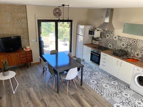 a kitchen and dining room with a table and chairs at Casa ponto Da Cruz t3 in Arcos de Valdevez