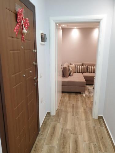 a living room with a couch and a door at Vacation Apartment near the lake Apartament afer liqenit in Pogradec