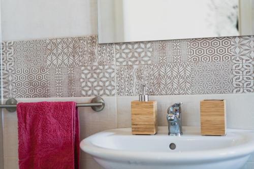 a bathroom with a sink and a red towel at La luna nel pozzo in Portoscuso