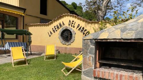 a group of lawn chairs in front of a building at Agriturismo La Gemma del Parco in Mormanno