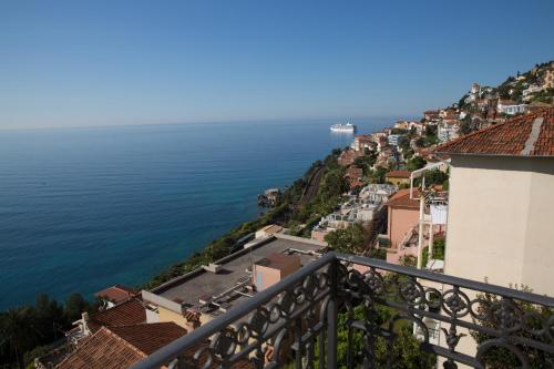 a view of the ocean from a city at Hotel de charme Regency in Roquebrune-Cap-Martin