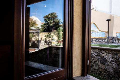 a sliding glass door with a view of a building at Hotel Garibaldi in Milazzo