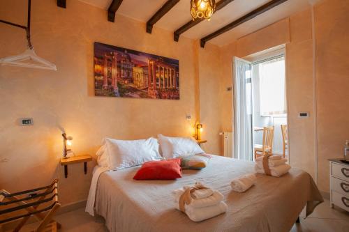 a bedroom with a large bed with towels on it at Rogiual in Rome