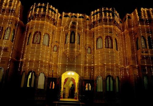 a large building with lights on it at night at Hotel Lal Garh Fort And Palace in Jaisalmer
