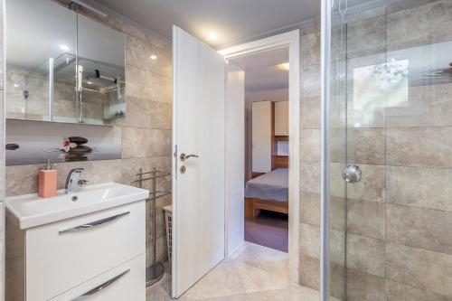 a bathroom with a sink and a shower at Holiday Home Michael in Pinezici