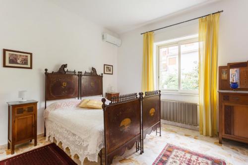 a bedroom with a bed and a window at At Armando's Home in Zafferana Etnea
