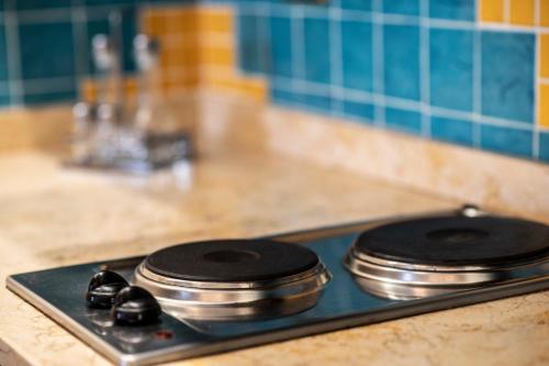 two pots and pans sitting on top of a stove at Hotel Garibaldi in Milazzo