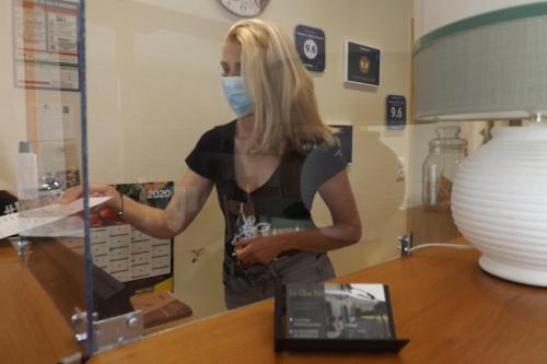 a woman wearing a face mask in a store at Chambres d'hôtes Le Clos Poli in Montigny-les-Monts