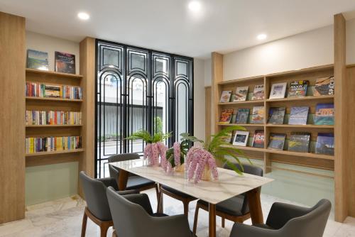 
a room filled with lots of books on a table at Oakwood Hotel & Residence Bangkok SHA Plus Certified in Bangkok
