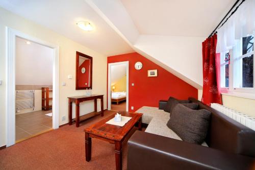 a living room with a couch and a table at Hotel Erika in Špindlerův Mlýn