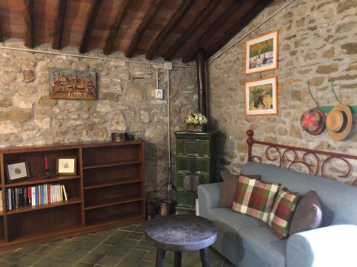 a living room with a couch and a table at Podere Pruneto in Radda in Chianti