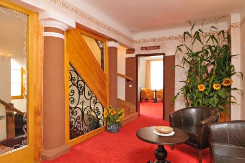 a living room with a table and a chair at Pension Lectar in Radovljica