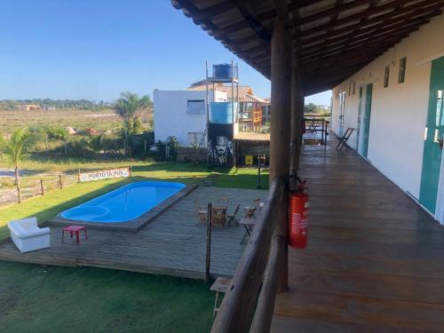 a wooden deck with a swimming pool on a house at Pousada Porto Taipus in Marau