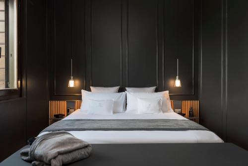 a bedroom with a large bed with white pillows at Relais Villa Margherita in Longiano