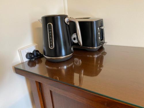 a table with two coffee makers on top of it at Seacroft Estate in Apollo Bay