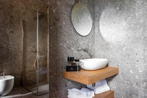 a bathroom with a sink and a shower and a mirror at Relais Villa Margherita in Longiano