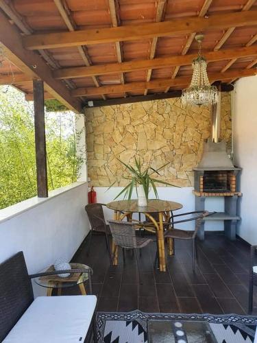 a dining room with a table and a stove at Quinta do Benjamim - Tejo "For 2, family, nature or relax" in Praia do Ribatejo