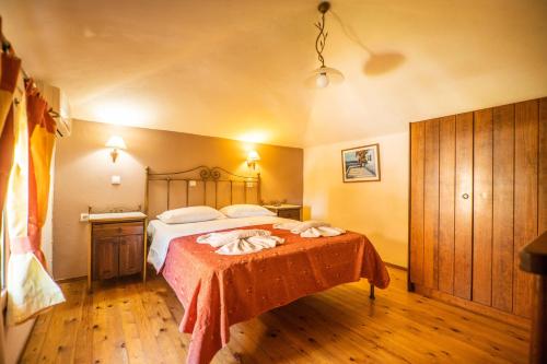 a bedroom with a large bed with a red blanket at Kokalas Resort in Georgioupolis