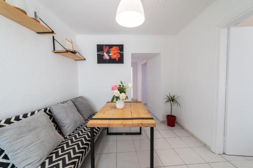 a living room with a couch and a wooden table at Simple Pleasures Home in Kavala