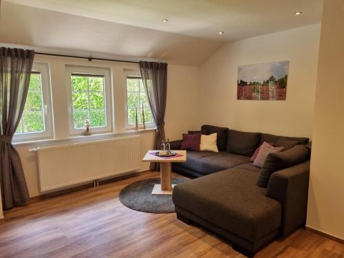 a living room with a couch and a table at Landhotel Hof Barrl in Schneverdingen
