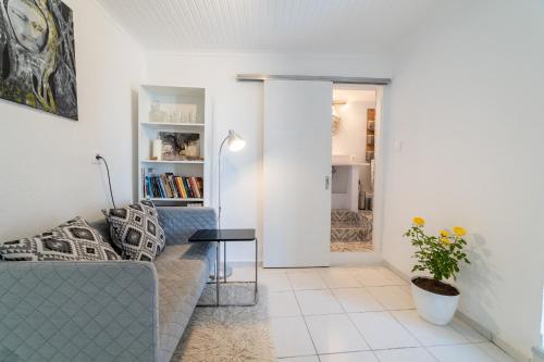 a living room with a couch and a table at Simple Pleasures Home in Kavala