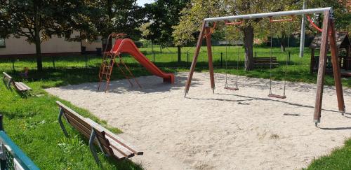 a playground with a red slide in a park at Ubytovani-prostejov in Prostějov