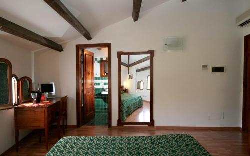 a bedroom with a bed and a mirror at La Magnolia Sorrento - City Centre Hotel in Sorrento