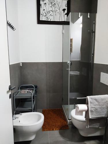 a bathroom with a white toilet and a sink at Da Ramona in Iseo