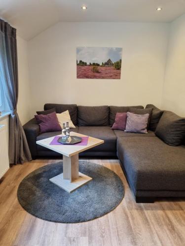 a living room with a couch and a table at Landhotel Hof Barrl in Schneverdingen