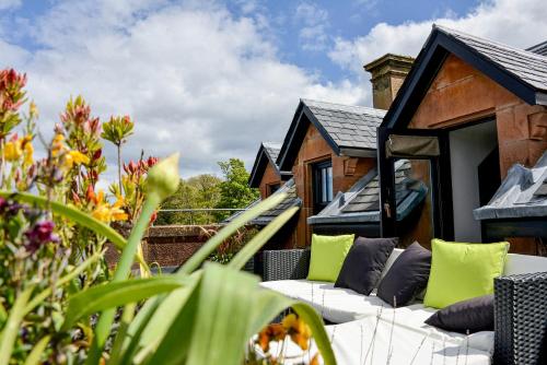 a garden with a couch and a house at The Douglas Hotel in Brodick