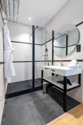 a bathroom with a sink and a mirror at Hotel Le Saint Gelais in Angoulême