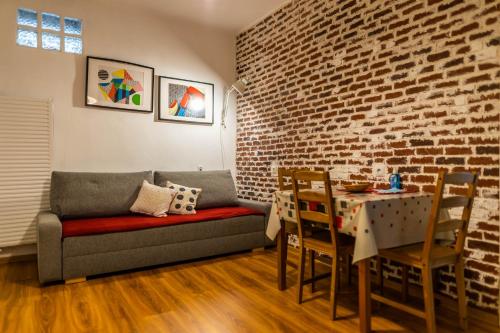 sala de estar con sofá, mesa y pared de ladrillo en Fifty shades of travel en Brasov