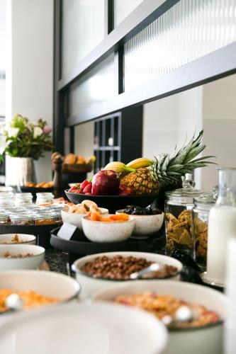 a buffet with many plates of food on a table at Noa Hotel in Thessaloniki