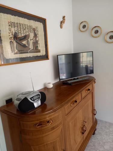 TV en la parte superior de una cómoda de madera en K&S 68 Appt Standing vue mer - Garage Inclus en Roquebrune-Cap-Martin