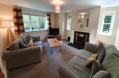 a living room with a couch and a coffee table at Chevin Country Park Hotel & Spa in Otley