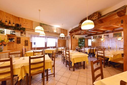 a restaurant with tables and chairs in a room at Hotel & Ristorante Serenella in Breuil-Cervinia