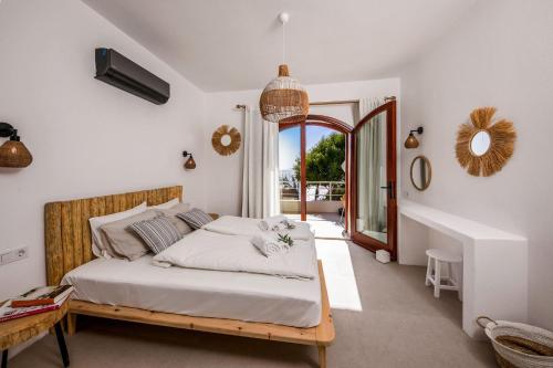 a bedroom with a bed and a large window at Kale Suites, heated pool in winter, adults only in Kaş
