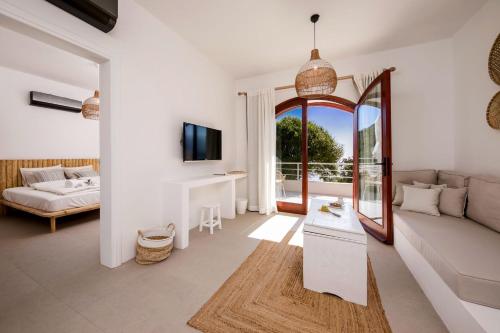a living room with a couch and a mirror at Kale Suites, heated pool in winter, adults only in Kaş