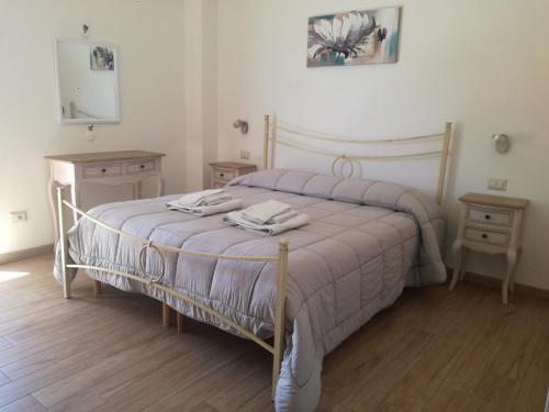 a bedroom with a bed with two towels on it at Apartment Conchiglie in Cala Gonone