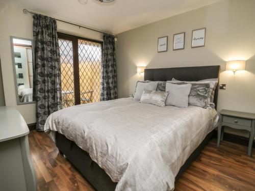 a bedroom with a large bed and a window at Fourth Milestone Granary in York