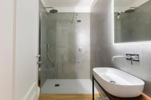 a white bathroom with a sink and a shower at Antico Borgo di Sutri in Sutri