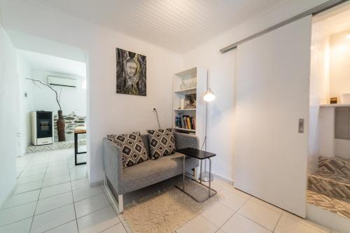 a living room with a couch and a table at Simple Pleasures Home in Kavala